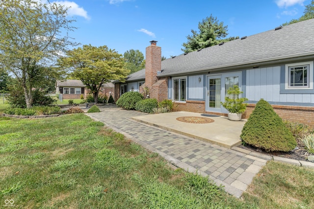 view of front of property with a patio and a front lawn