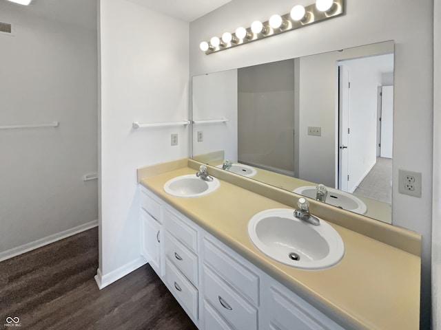 bathroom with wood-type flooring and double sink vanity