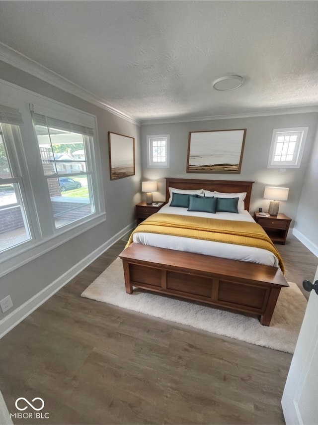 bedroom featuring multiple windows, hardwood / wood-style floors, and crown molding