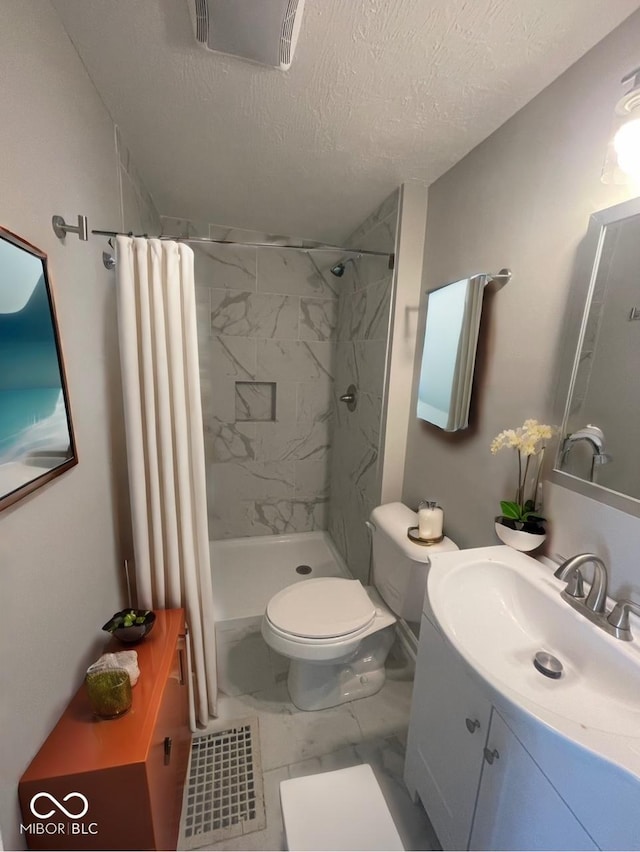 bathroom featuring vanity, toilet, curtained shower, and a textured ceiling