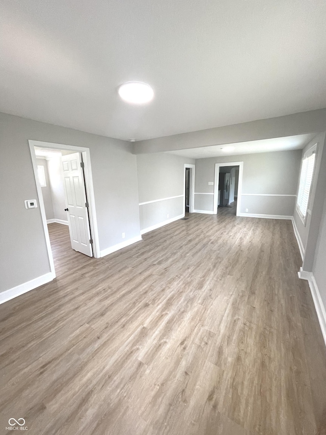 unfurnished living room with wood-type flooring