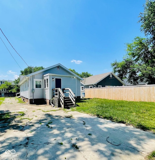 back of property featuring a lawn