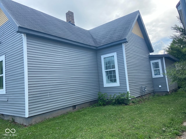 view of side of home featuring a lawn