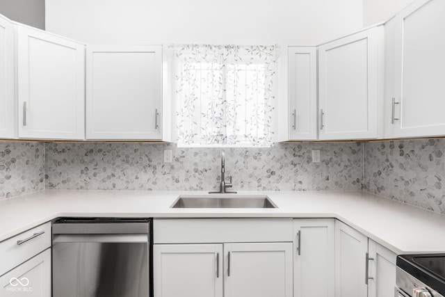 kitchen featuring decorative backsplash, sink, stainless steel appliances, and white cabinets