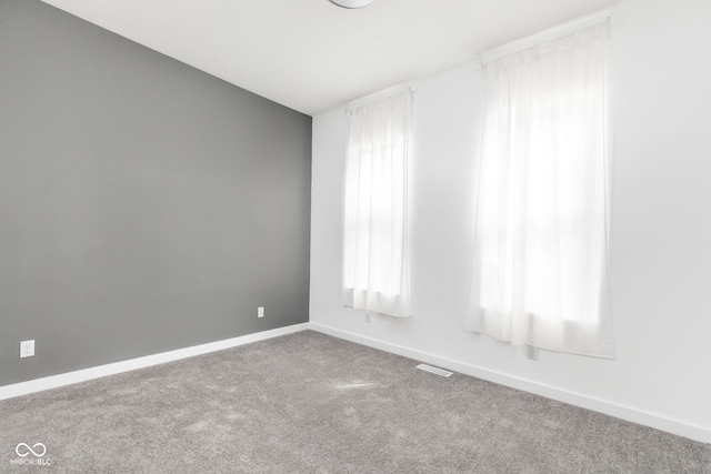 unfurnished room featuring carpet