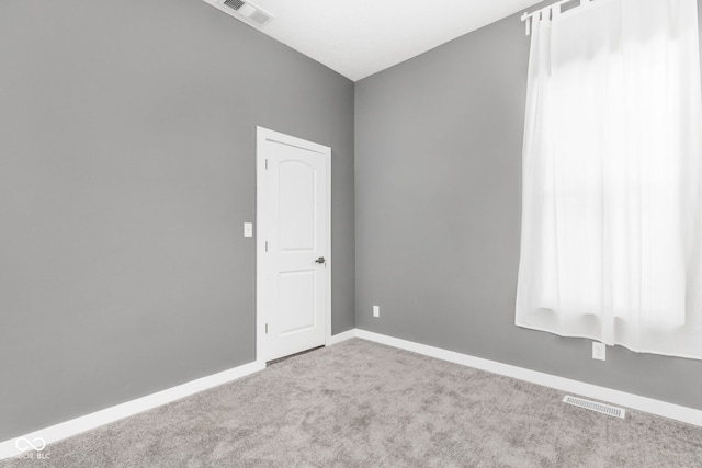 empty room featuring light colored carpet