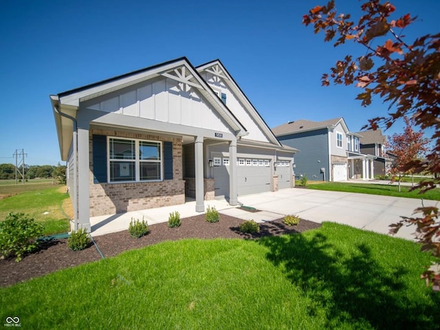 craftsman house with a front yard and a garage