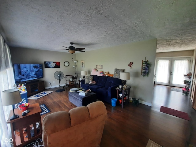 living room with dark hardwood / wood-style floors, a textured ceiling, ceiling fan, and french doors