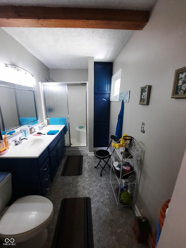 bathroom with vanity, beam ceiling, a shower with door, and toilet