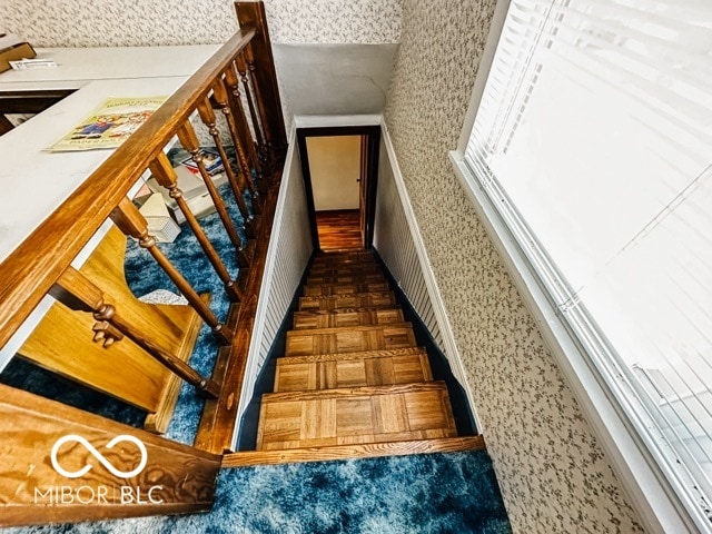 stairs featuring parquet floors