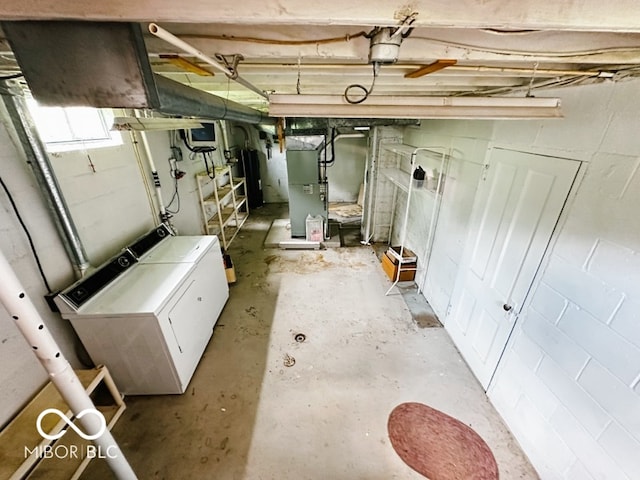 basement featuring washer and dryer and heating unit