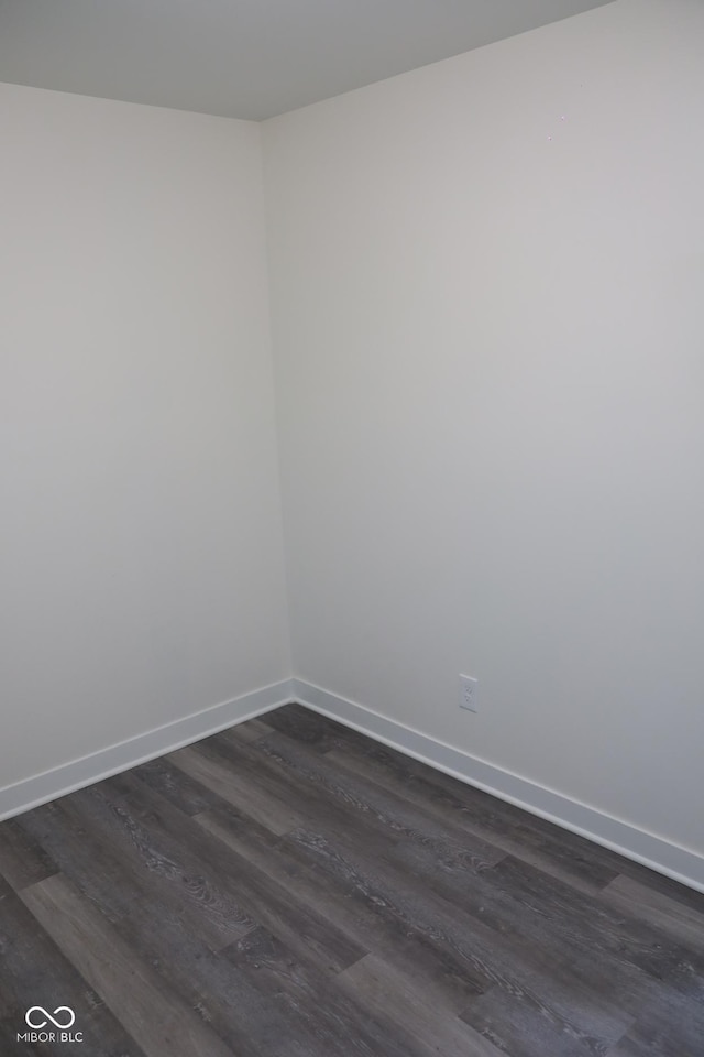 empty room with dark hardwood / wood-style flooring