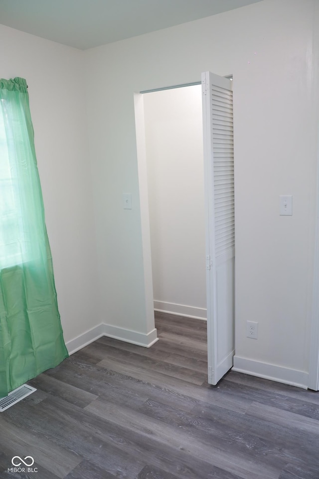 unfurnished room featuring dark hardwood / wood-style floors