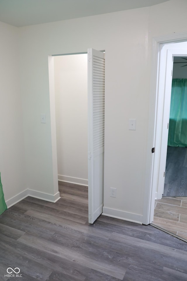 interior space featuring dark hardwood / wood-style flooring and a closet