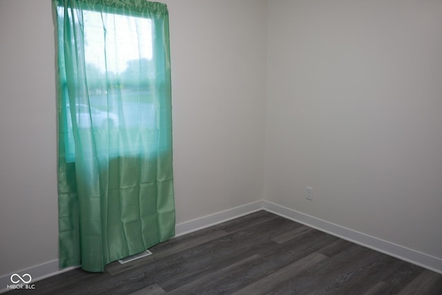 unfurnished room featuring dark hardwood / wood-style floors