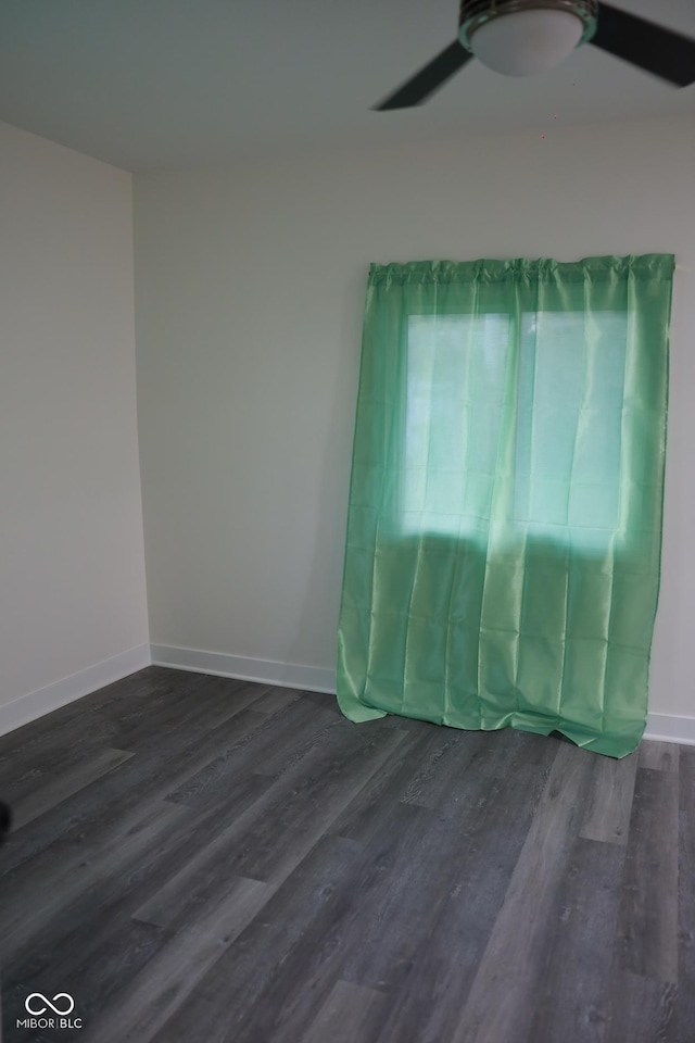 spare room featuring dark hardwood / wood-style floors and ceiling fan