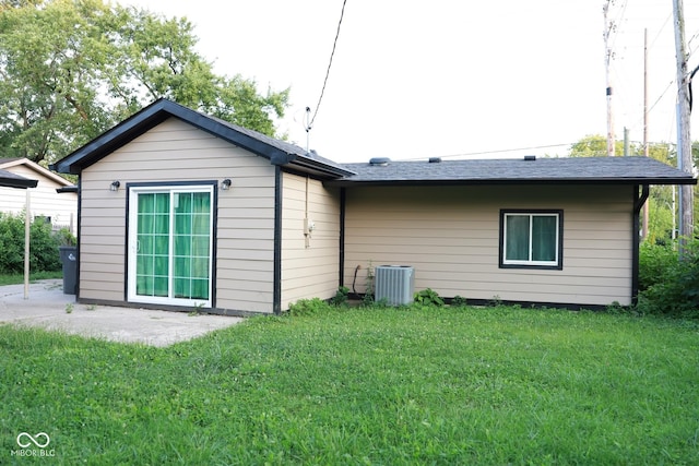 back of property with a patio, a lawn, and central air condition unit