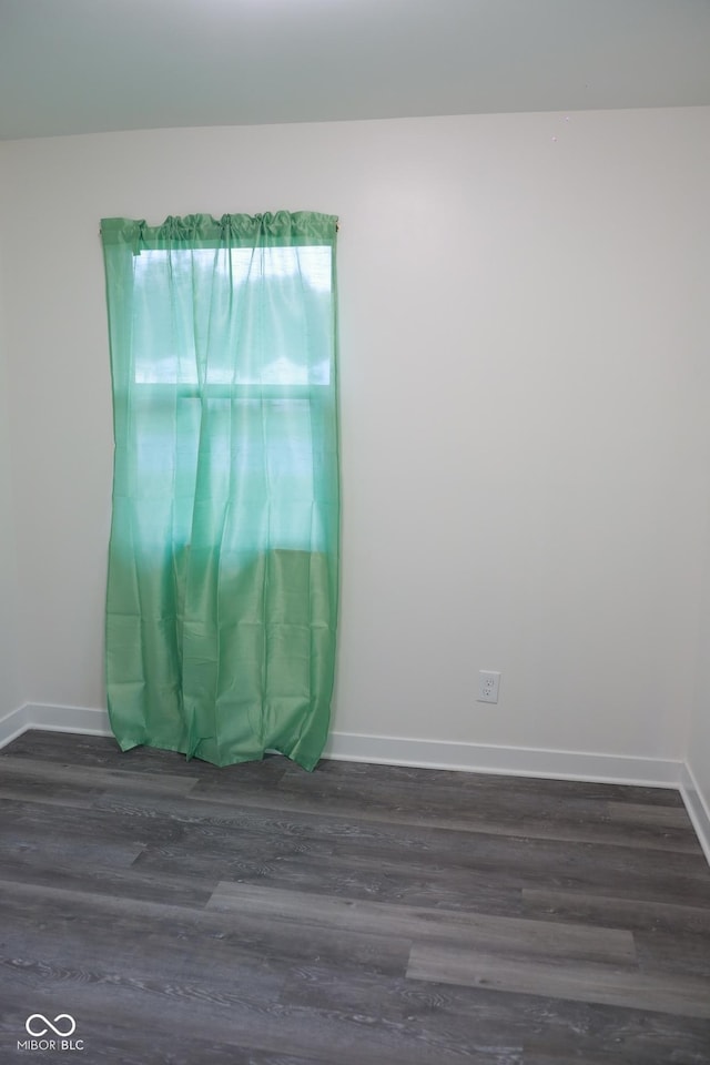 empty room featuring dark hardwood / wood-style flooring