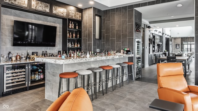 bar featuring tile walls, wine cooler, and tile patterned floors