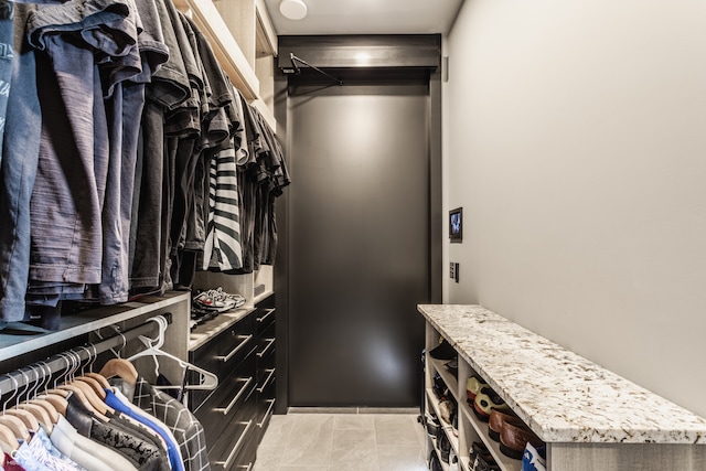 walk in closet featuring light tile patterned floors