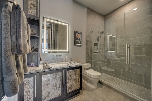 bathroom with vanity, a shower with shower door, toilet, and tile patterned floors