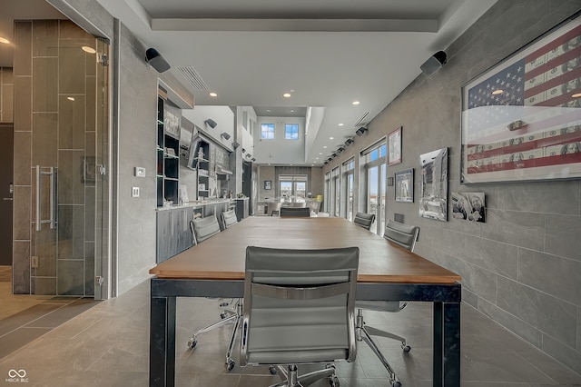 dining room featuring tile patterned flooring and a tray ceiling