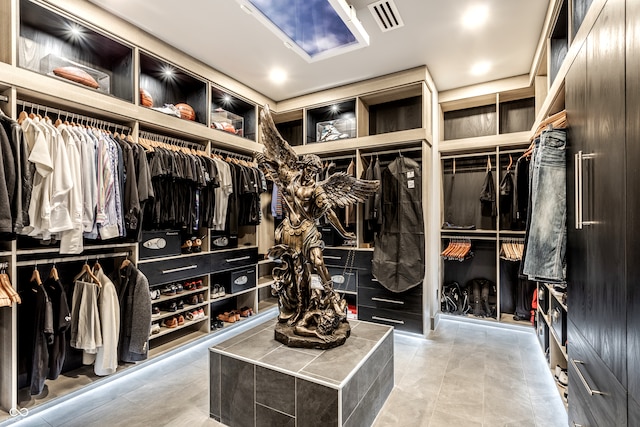 spacious closet with light tile patterned floors