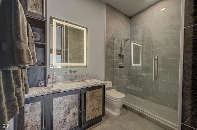 bathroom with vanity, walk in shower, tile patterned flooring, and toilet