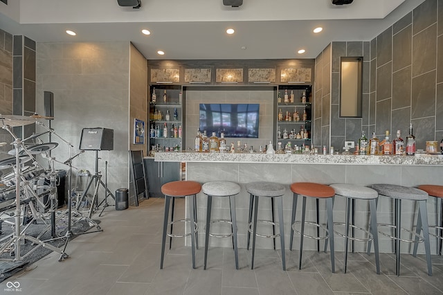 bar with tile walls and tile patterned floors