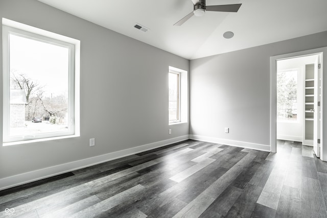 empty room featuring dark hardwood / wood-style floors, ceiling fan, and lofted ceiling