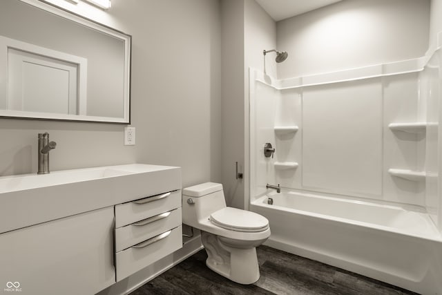 full bathroom with vanity, shower / washtub combination, wood-type flooring, and toilet