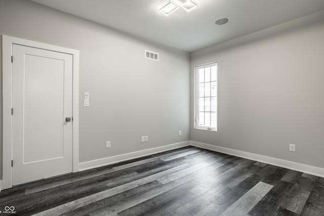 spare room featuring dark hardwood / wood-style flooring