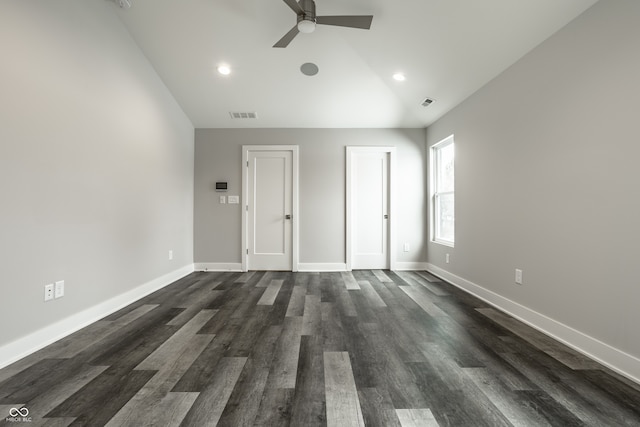 spare room with dark wood-type flooring, lofted ceiling, and ceiling fan