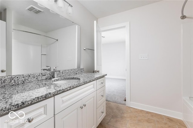 bathroom featuring tile patterned flooring, shower / washtub combination, and vanity