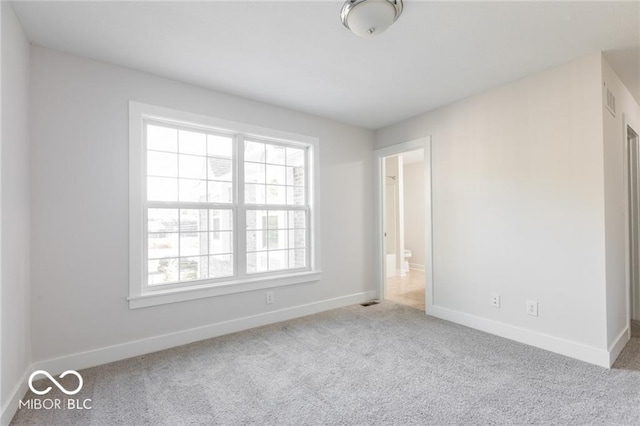 empty room featuring light carpet