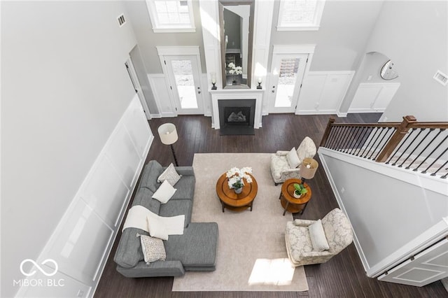 living room with hardwood / wood-style floors and a high ceiling