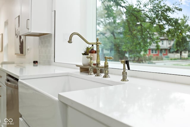 3031 N New Jersey St, Indianapolis, IN 46205 - room details featuring light countertops, a sink, white cabinetry, tasteful backsplash, and stainless steel dishwasher