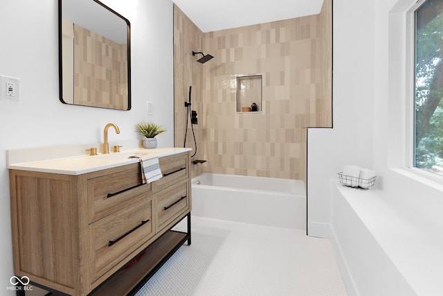 bathroom with tiled shower / bath, vanity, and tile patterned floors