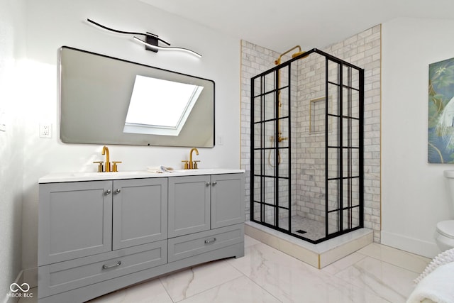 bathroom with a tile shower, vanity, a skylight, and toilet