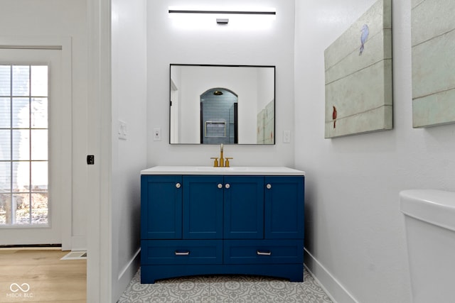 bathroom featuring hardwood / wood-style floors, vanity, and toilet