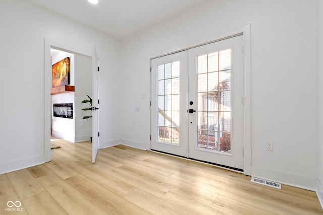 doorway featuring light hardwood / wood-style flooring and french doors