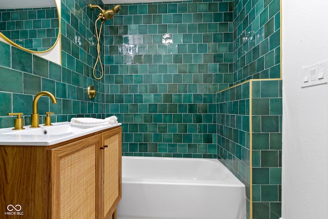 bathroom featuring vanity, tiled shower / bath, and backsplash