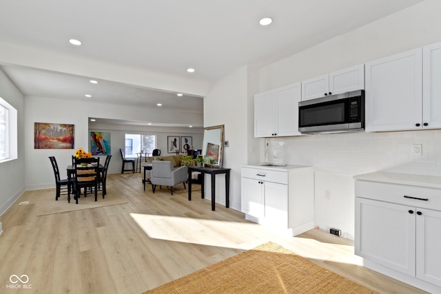 2936 N New Jersey St, Indianapolis, IN 46205 - kitchen featuring stainless steel microwave, white cabinetry, decorative backsplash, light wood finished floors, and recessed lighting