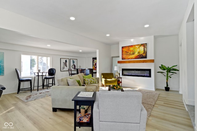 2936 N New Jersey St, Indianapolis, IN 46205 - living room featuring a glass covered fireplace, light wood-type flooring, recessed lighting, and baseboards