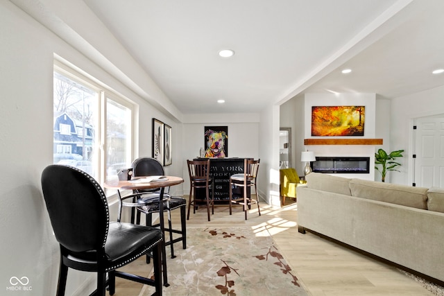 2936 N New Jersey St, Indianapolis, IN 46205 - living room featuring light wood finished floors, a glass covered fireplace, recessed lighting, and baseboards