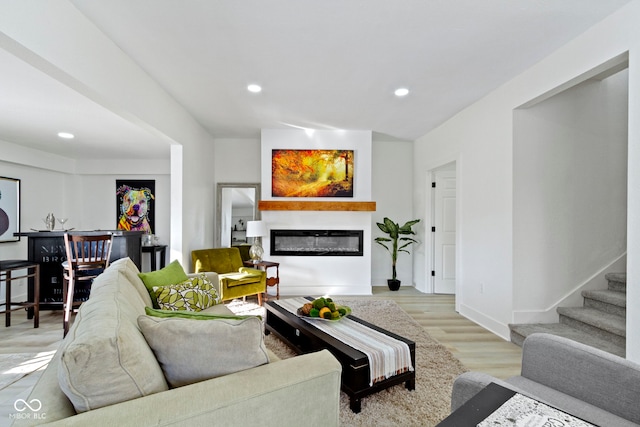 2936 N New Jersey St, Indianapolis, IN 46205 - living area featuring recessed lighting, light wood finished floors, a glass covered fireplace, stairway, and baseboards