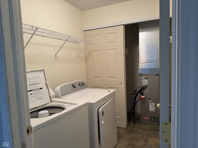 washroom featuring dark tile patterned flooring and washing machine and clothes dryer