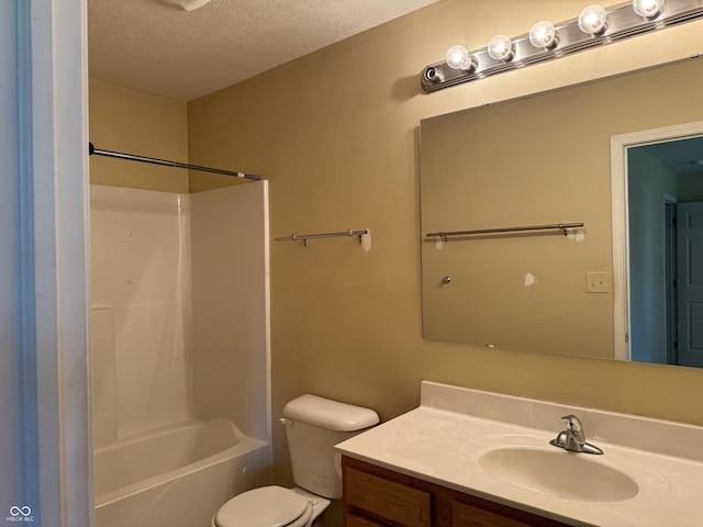 full bathroom featuring vanity, washtub / shower combination, a textured ceiling, and toilet