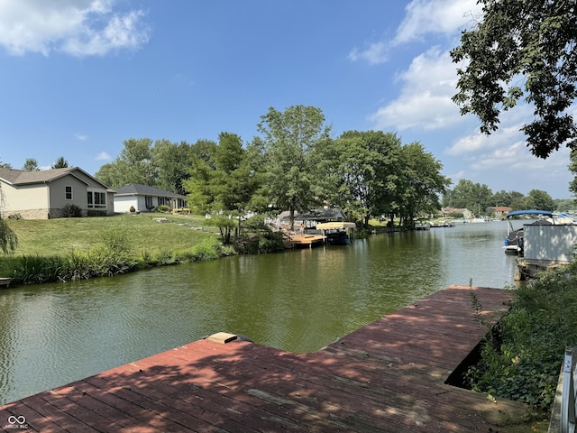 view of dock featuring a water view and a yard