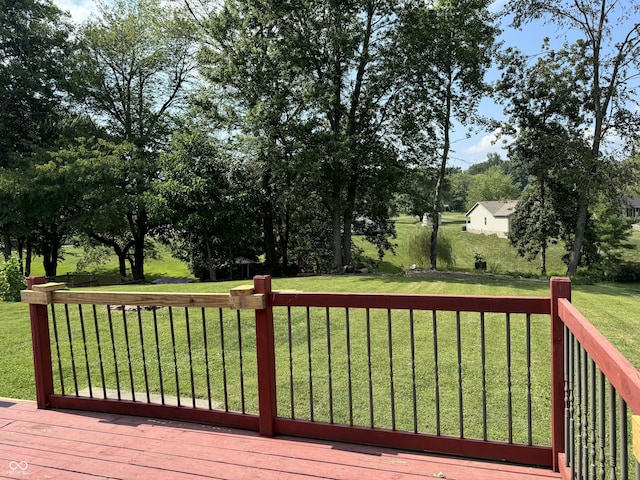 wooden deck with a lawn